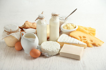Set of fresh dairy products on white wooden table