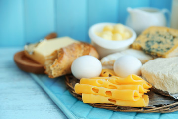 Set of fresh dairy products on blue wooden table, close up