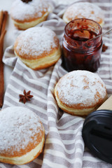 Obraz na płótnie Canvas Fresh homemade donuts with powdered sugar, close up