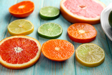 Juicy composition of citrus fruits on wooden background, close up