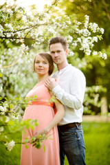 Fototapeta premium Couple in love under blooming branches spring day.