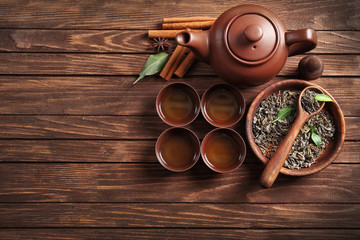 Green tea with ceramic utensils on wooden background