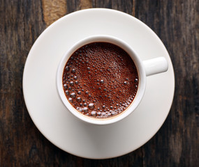 Cup of hot coffee on rustic wooden background