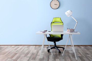 Modern workplace with office chair and laptop