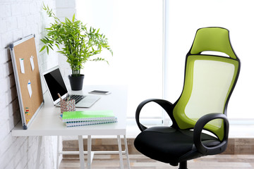 Modern workplace with office chair and laptop