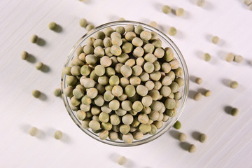 Raw pea seeds on glass bowl