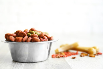 Bowl with dog food on the floor in front of brick wall background