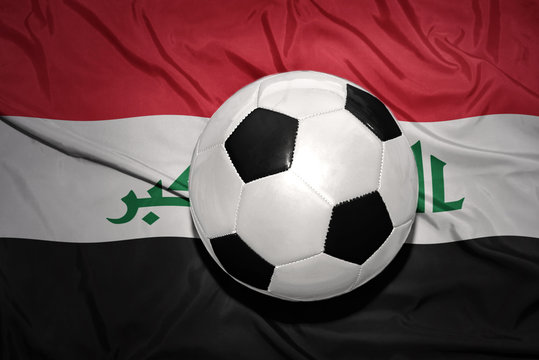 black and white football ball on the national flag of iraq