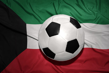 Fototapeta premium black and white football ball on the national flag of kuwait