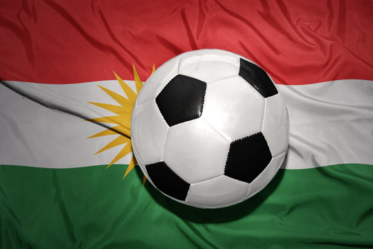 black and white football ball on the national flag of kurdistan