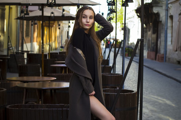 Stylish woman in coat at the street