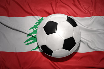 black and white football ball on the national flag of lebanon
