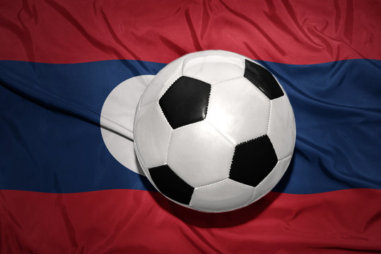 black and white football ball on the national flag of laos