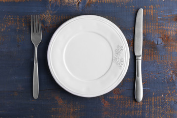 Set of dinnerware on wooden table