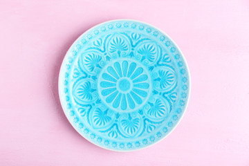 Empty plate on pink background