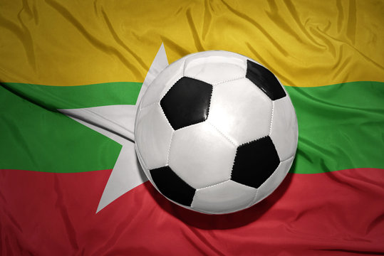 black and white football ball on the national flag of myanmar