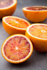 Mixed citrus fruit figs, limes on a gray background.