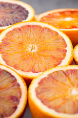 Mixed citrus fruit figs, limes on a gray background.