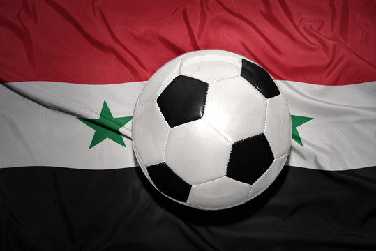 black and white football ball on the national flag of syria