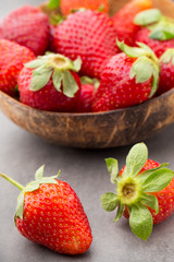 Strawberry in a bowl on the gray background.