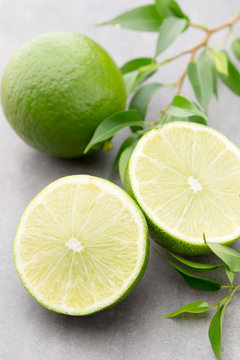 Juicy ripe lime an gray table.