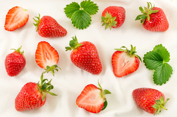Fototapeta na wymiar Fresh strawberries on a white silk fabric