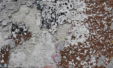 Cracked wall with white spots of paint. Vintage background.