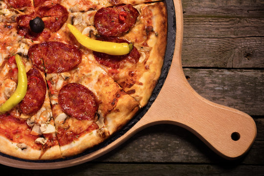 Hot spicy pepperoni pizza with sausage, ham and chilly pepeer se