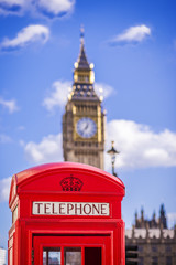 The Big Ben with classic red English telephone box on a sunny afternoon with blue sky and clouds - London, UK