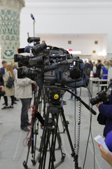 Professional television video cameras on a tripods at the shooting scene