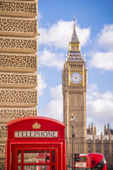 Fototapeta na wymiar Traditional red british telephone box with iconic double decker bus and Big Ben at the background - London, UK