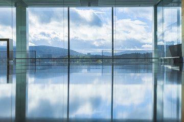 Empty interior of modern building with reflection of blue sky