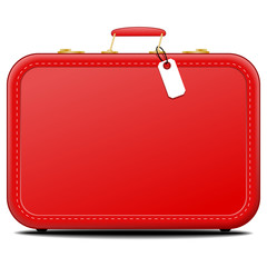 Red suitcase with blank tag on surface