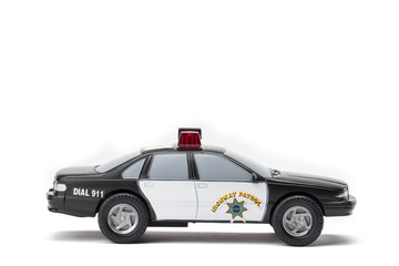 miniature police car on white background