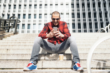 Young man with mobile phone and fixed gear bicycle.