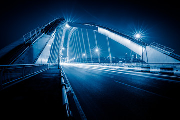 traffic trails on bridge,chongqing china,blue toned image.