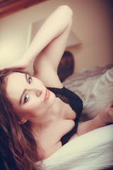 Naklejka premium Portrait seductive young woman in lingerie in bed.