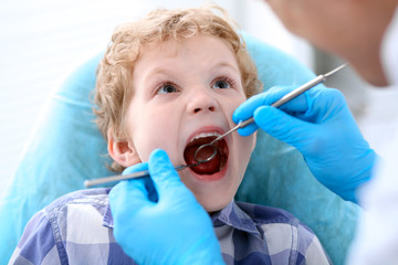 Close up of boy having his teeth examined by a dentist