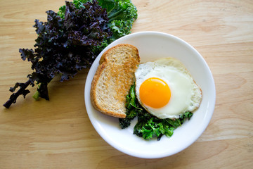 Local kale and a beautiful sunny side egg for a quick and easy weekday breakfast.