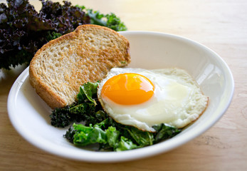 Local kale and a beautiful sunny side egg for a quick and easy weekday breakfast.
