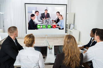 Businesspeople Videoconferencing At Workplace