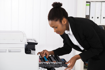 Businesswoman Fixing Photocopy Machine