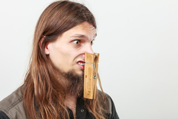 Man with clogged nose by clothespin