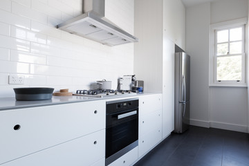 Monochrome clean white kitchen benchtop with appliances