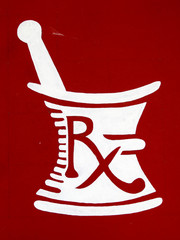 Painted Rx symbol on a wall, white on red