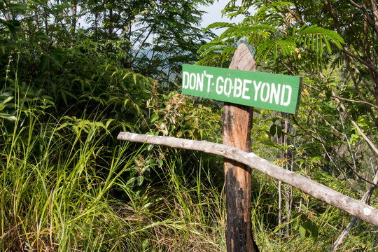 "Don't go beyond" sign and railing in Belize