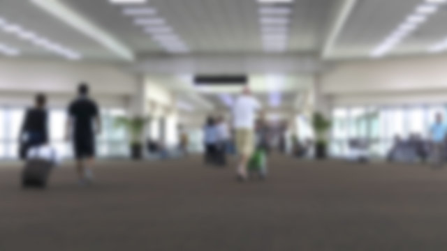 people in airport terminal, blur background