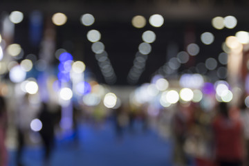 people in exhibition hall building, blur background