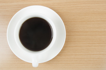 Black coffee with top view on wooden background