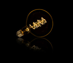 Lightbulb on black background with nice reflection